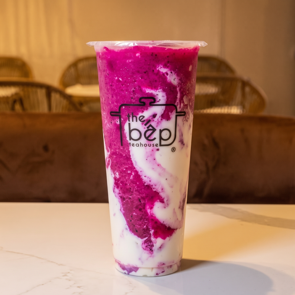 Dragon fruit smoothie with pink and white swirls in a The Bep Teahouse cup.